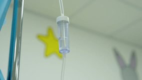 Medical drip chamber hanging in pediatric hospital room, steadily delivering essential fluids and targeted medications while supporting young patient's recovery process - Powered by Shutterstock - Get 15% off with code: PIKWIZARD15