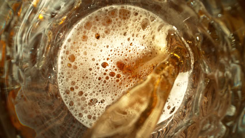 Super Slow Motion of Pouring Beer into Pint Glass, Top Down View, Camera Move. Filmed on High Speed Cinema Camera, 1000 fps.