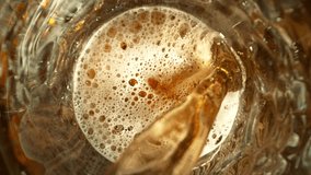 Super Slow Motion of Pouring Beer into Pint Glass, Top Down View, Camera Move. Filmed on High Speed Cinema Camera, 1000 fps. - Powered by Shutterstock - Get 15% off with code: PIKWIZARD15