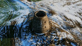 Aerial orbit of medieval stone ruins in snowy winter landscape at golden hour - Powered by Shutterstock - Get 15% off with code: PIKWIZARD15