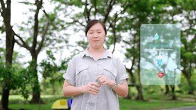 Happy Asian woman in a park using a health tech app on her smartphone to track hydration and drinking water, illustrating a modern wellness lifestyle and digital health concept. - Powered by Shutterstock - Get 15% off with code: PIKWIZARD15