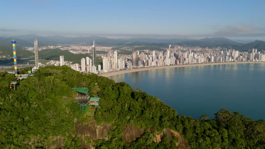 Amazin aerial panorama at Parque Unipraias mountain chatel to the Balneário Camboriú coastal skyline viewed from lush green hilltop and touristic side, Santa Catarina, Brazil.