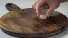 Three natural homemade lip balms in clear containers on brown background. DIY beauty products in red, brown, and transparent shades, organic skincare, handmade cosmetics, and eco-friendly style. - Powered by Shutterstock - Get 15% off with code: PIKWIZARD15