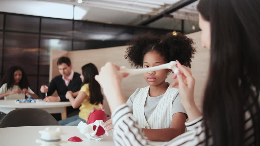 Group of student girls brainstorm and discuss with their teachers