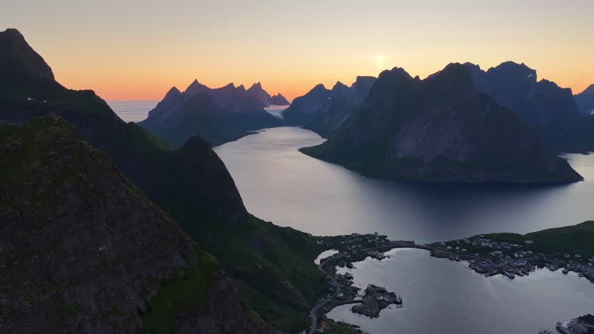 Reine, norway, at sunset: showing majestic mountains, fjord, and fishing village
