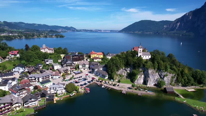 Austrian most beautiful lakes - Traunsee, aerial view of scenic village peninsola Traunkirchen . aerial drone 4k hd footage. Salzkammergut, Austria tourism