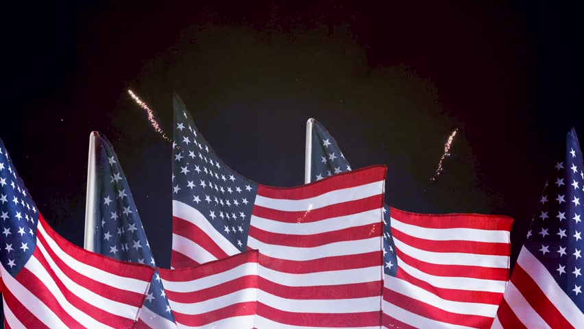 Independence Day holiday night with fireworks and American flag. USA flag symbolizing celebration, freedom, and patriotism.