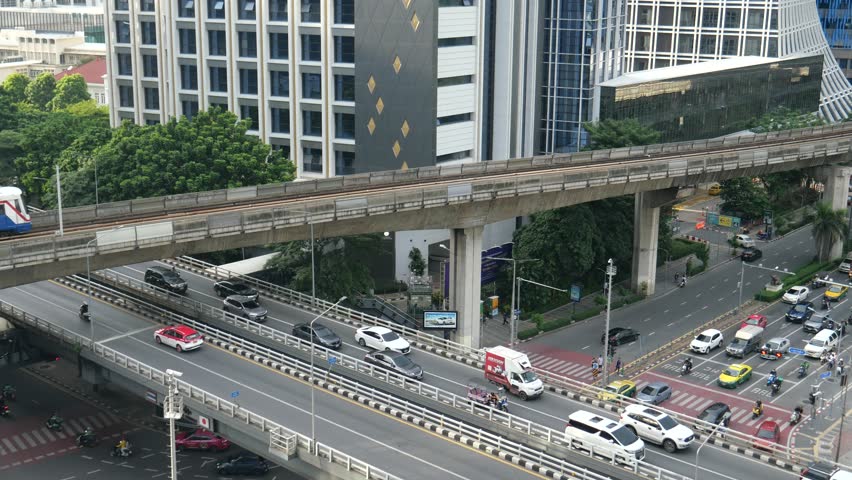 BTS train, traffic, city buildings and Lumpini park in Bangkok