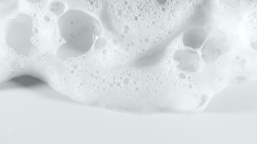 Texture of white soap foam with bubbles abstract background. Soap sud macro structure. Bathtup Soap Foam. Natural White Shampoo Bubbles Motion.