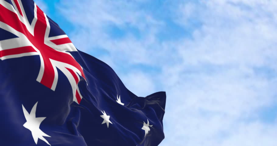 Australia national flag waving in the wind. Blue flag with Union Jack, white 5-pointed star symbolizing Southern Cross. Seamless 3d render animation. Slow motion loop. Selective focus