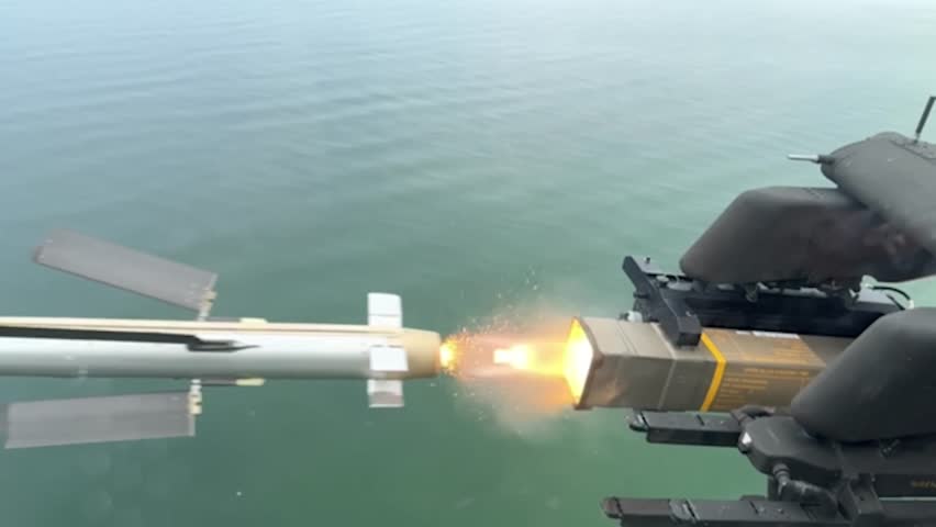 AH-64E Apache Guardian helicopter fires Spike NLOS missile.