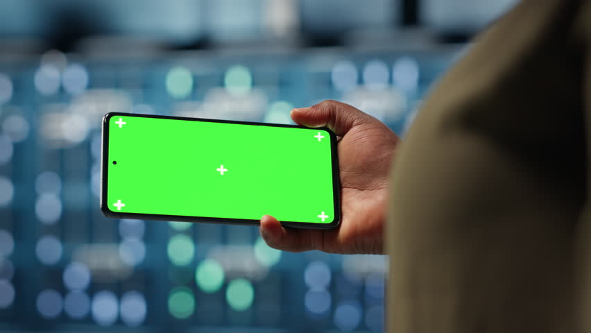 Server hub admin uses isolated screen smartphone to watch video tutorial on how to increase rigs workload capacity. Data center worker following guide on chroma key phone to improve speed, camera B - Powered by Shutterstock - Get 15% off with code: PIKWIZARD15
