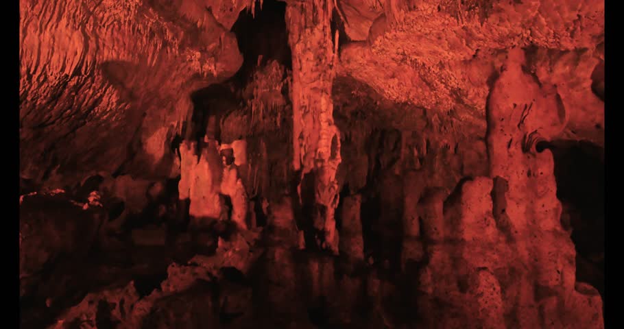 4K video capturing the red-lit stalactites and stalagmites inside Tokat Ballıca Cave, showcasing the unique colors and natural geological formations in this underground wonder.