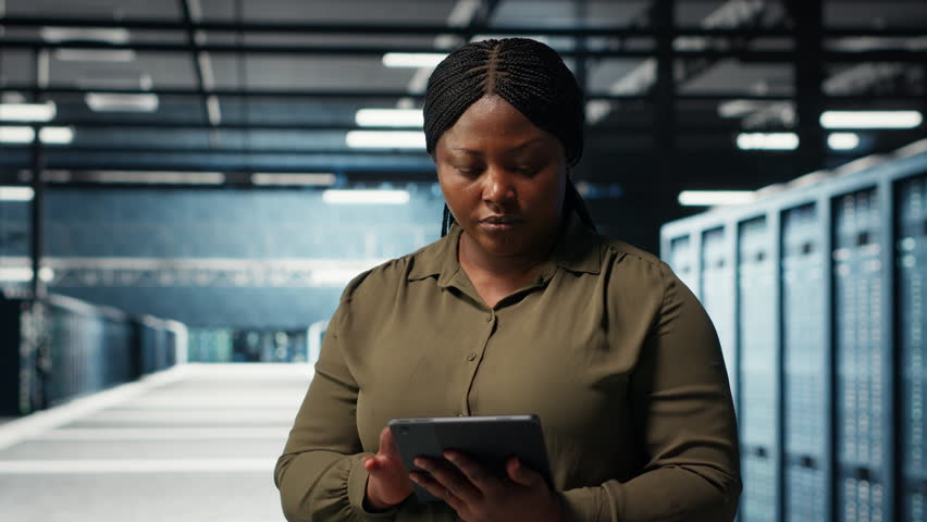 Close up of admin working in data center managing and optimizing network infrastructure. IT expert walking through server room rows diagnosing and resolving hardware malfunctions