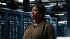 Portrait of cheerful data center engineer conducting security audits to protect against cyber threats. Jolly worker walking in server room, ensuring compliance with industry standards, camera B - Powered by Shutterstock - Get 15% off with code: PIKWIZARD15