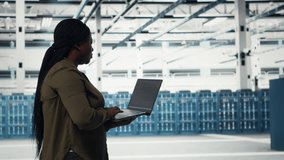 Data center worker using laptop to manage software updates for system stability. African american woman in server room configuring infrastructure for optimum performance, camera B - Powered by Shutterstock - Get 15% off with code: PIKWIZARD15