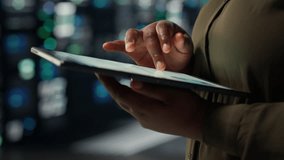 Close up of technician working in data center using tablet to optimize network infrastructure. IT expert in server farm diagnosing and resolving hardware malfunctions using device - Powered by Shutterstock - Get 15% off with code: PIKWIZARD15