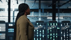 System administrator working in data center to optimize network infrastructure. African american woman in in server farm diagnosing and resolving hardware malfunctions using device - Powered by Shutterstock - Get 15% off with code: PIKWIZARD15