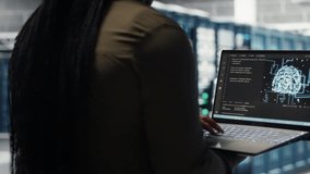 Data center engineer doing AI data analysis on laptop to upgrade infrastructure. Server room worker using notebook to manage storage systems for machine learning training datasets - Powered by Shutterstock - Get 15% off with code: PIKWIZARD15