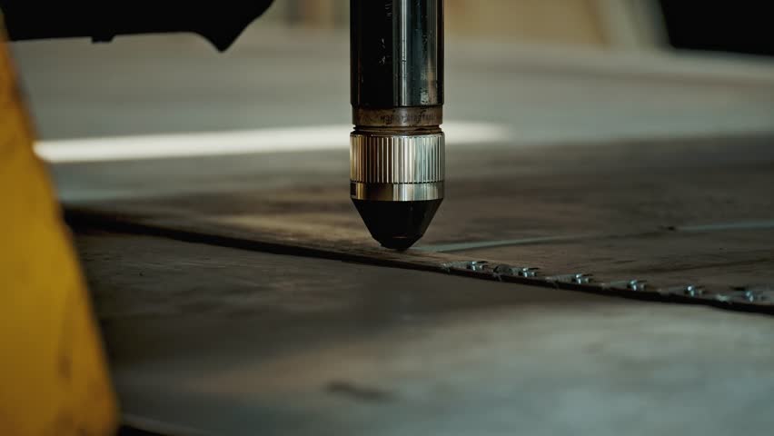 CNC Laser Cutting Machine Slices Metal Sheet with Precision and Bright Sparks. Industrial Manufacturing Process with Plasma Light and Modern Automation Technology. Industry in Slow motion Close-up 4k