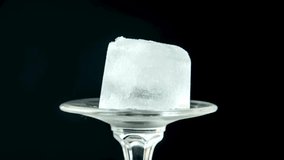 Melting Ice Cube on Glass - Slow Motion Macro with Black Background - Powered by Shutterstock - Get 15% off with code: PIKWIZARD15
