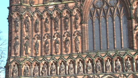The many stone carved religious figures adorning the west front of Lichfield Cathedral in Staffordshire.