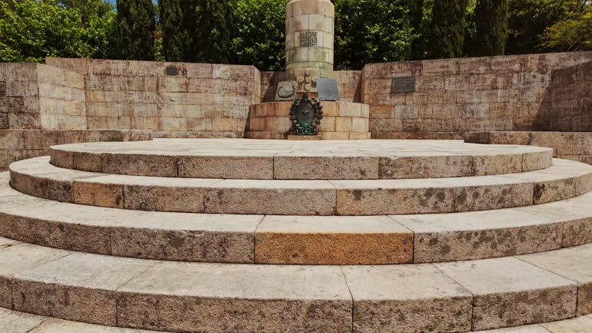 The statue of Afonso Henriques depicts the first Portuguese king with sword and shield standing resolutely before the castle walls in Guimaraes, Portugal
