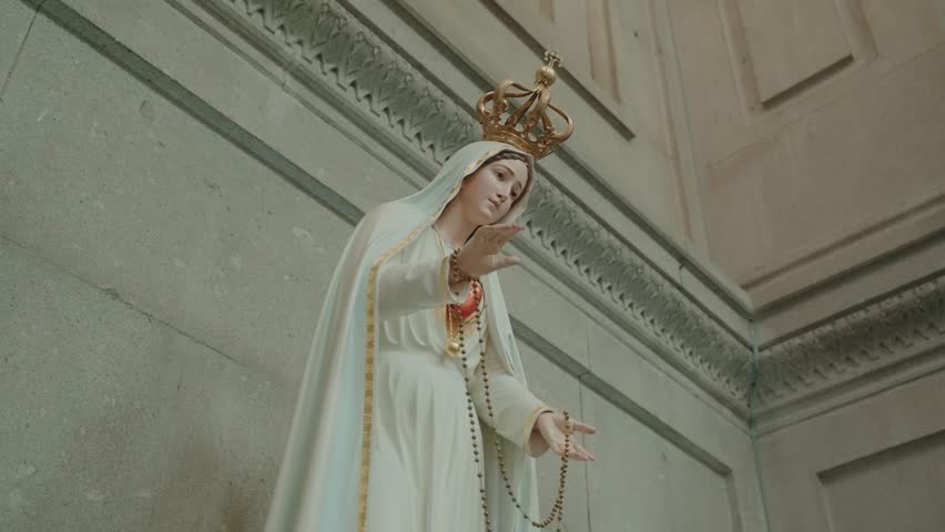 ornate statue of virgin mary with crown and rosary inside church