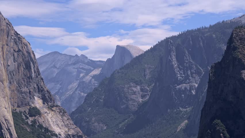 Closeup of Yosemite’s Half Dome granite cliff with a smooth zoom out.