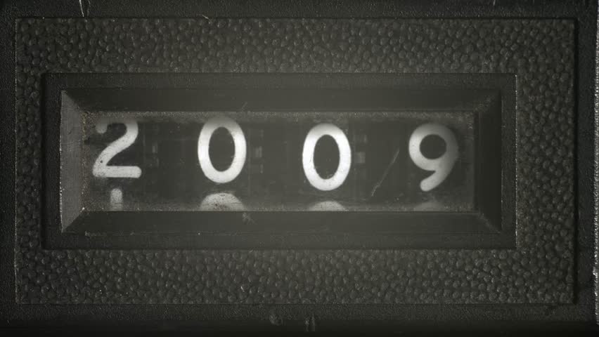 Vintage counter scrolls rapidly backwards from 2009 to 1901, retro numeric display symbolizing rewinding time, countdown, and a century of history in fast motion.
