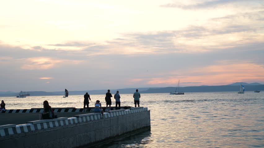 Fishing from the pier at sunset. Vladivostok Russia