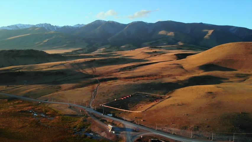 Vast mongolian steppe landscape showing mountains and farm. Media