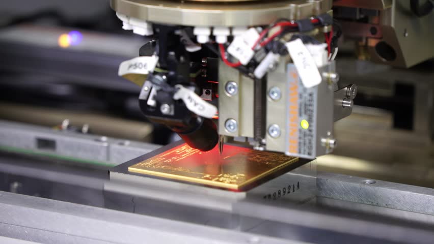 Close-up of Precision Machine Working on PCB Circuit Board