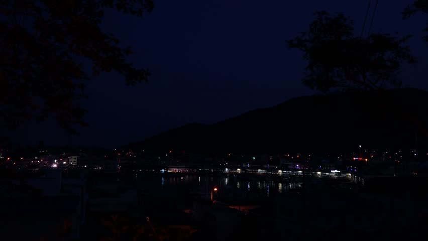 Time-lapse aerial drone footage of Samcheonpo Port in Sacheon, Gyeongsangnam-do, South Korea, capturing the vibrant harbor activities and diverse coastal cityscape.