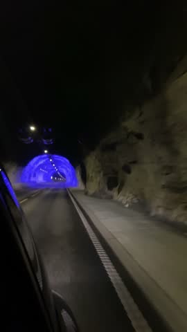 Tunnel in Norway with violet lights, road