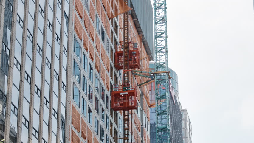 High Rise Building Construction with Tower Crane and Hoist