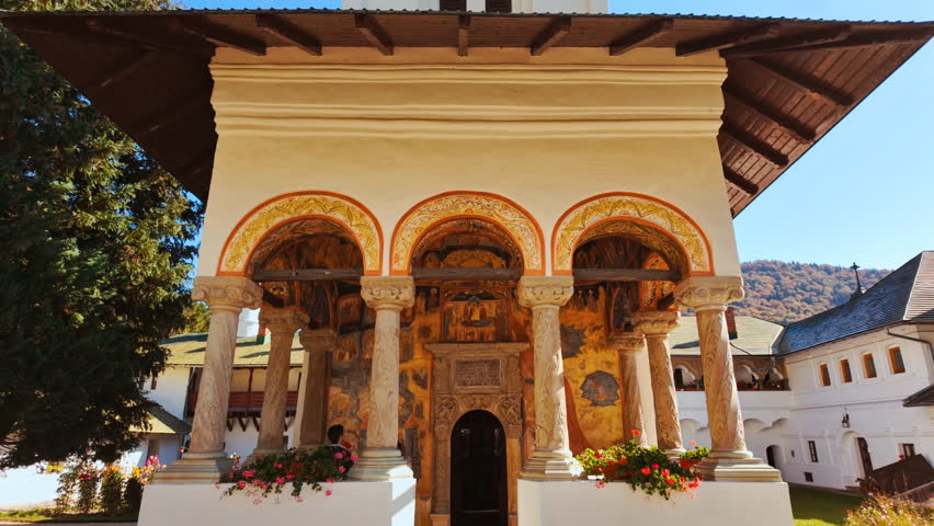 Exterior of the Sinaia Orthodox Monastery, Sinaia, Transylvania, Romania, shows stone walls, arched windows, and a compact courtyard, conveying the monastic ensemble and its calm proportions
