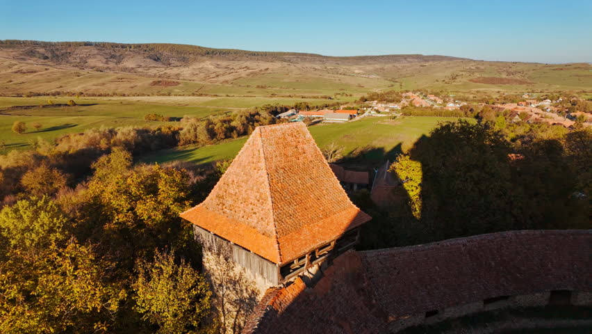 Viscri fortified church and the surrounding village and countryside, Transylvania, Romania, unites a hilltop church, enclosing walls, cobbled lanes, and open fields
