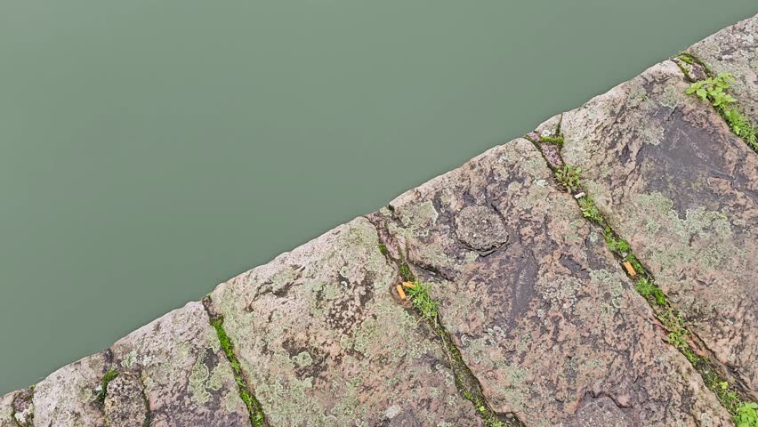 Stone bridge above calm river water