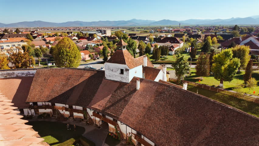 Viscri fortified church and the surrounding village and countryside, Transylvania, Romania, unites a hilltop church, enclosing walls, cobbled lanes, and open fields
