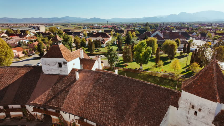 Viscri fortified church and the surrounding village and countryside, Transylvania, Romania, unites a hilltop church, enclosing walls, cobbled lanes, and open fields
