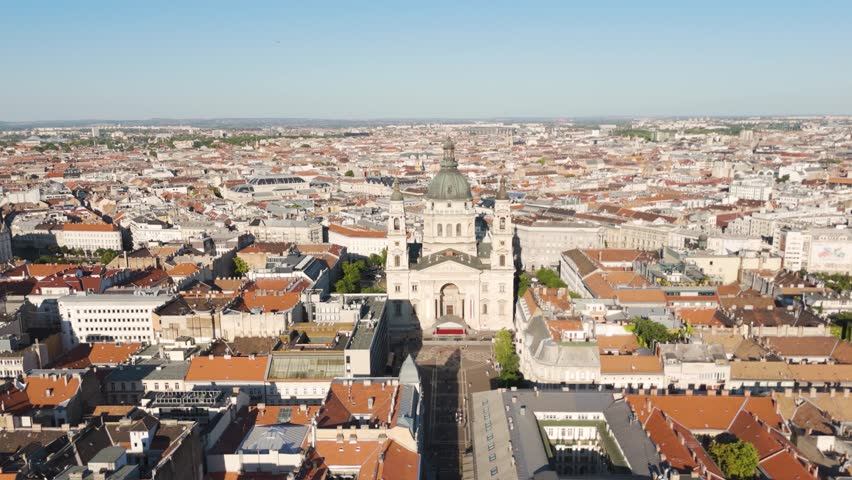 Aerial view of St. Stephen’s Basilica in Budapest, Hungary, showing its majestic dome and towers rising above the surrounding urban landscape