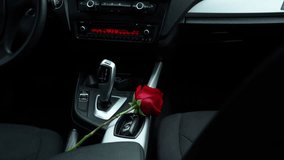 A red rose lying in the car. Romantic expectation, a love story. A flower as a gift for a girl.	 - Powered by Shutterstock - Get 15% off with code: PIKWIZARD15