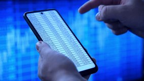 Businessman hands using a smart phone displaying financial data, against a vibrant blue stock market background. Concept of trading. - Powered by Shutterstock - Get 15% off with code: PIKWIZARD15
