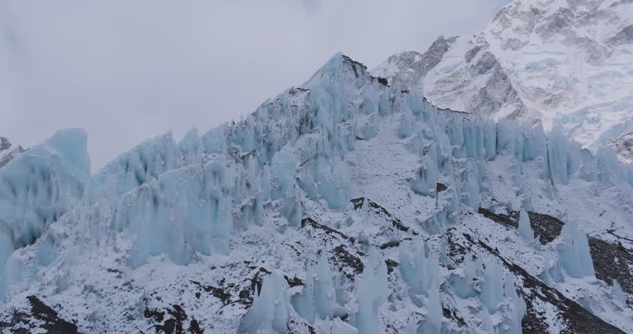 Drone shot Khumbu Glacier near Everest Base Camp, Sagarmatha, Nepal. Pointy Himalayan peaks reveal melting ice, snow-fed rivers, glacier outburst risks, highlighting tourism urgent nature protection