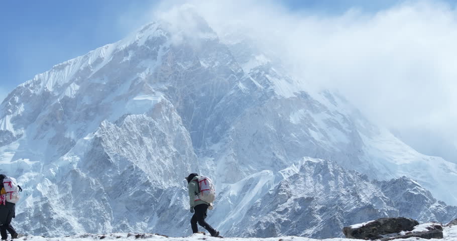 Drone shot of tourists climbing on Everest Base Camp trek in Khumbu, Nepal. Morning sunshine reveals snow-capped 8000m Himalayan mountains, breathtaking landscapes heavenly travel feeling