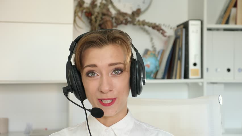 Portrait of woman call center worker wearing headphones with microphone.