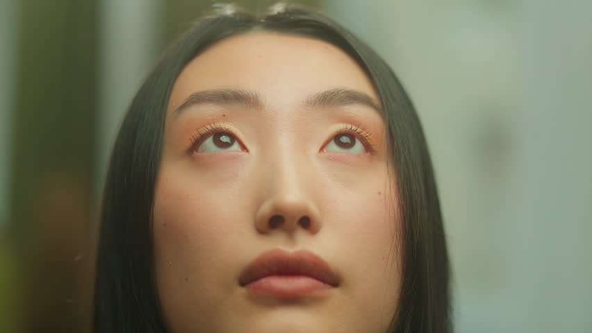Close up Asian woman looking up thinking inspired dreaming portrait Korean Japanese Chinese girl female pensive dreamy face dream praying religion pray think hope faith beauty skin indoors in studio