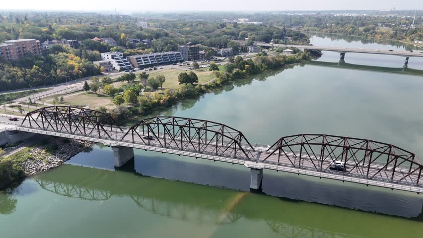 4K aerial view of Nutana in Saskatoon, looking over Rotary Park and the South Saskatchewan River with stunning city and riverside scenery.