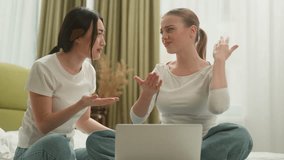 Two multiracial women stressed disappointed with laptop on bed with computer error friends female diversity Caucasian Asian Japanese Chinese girls lost web money exams failure bad news reading at home - Powered by Shutterstock - Get 15% off with code: PIKWIZARD15
